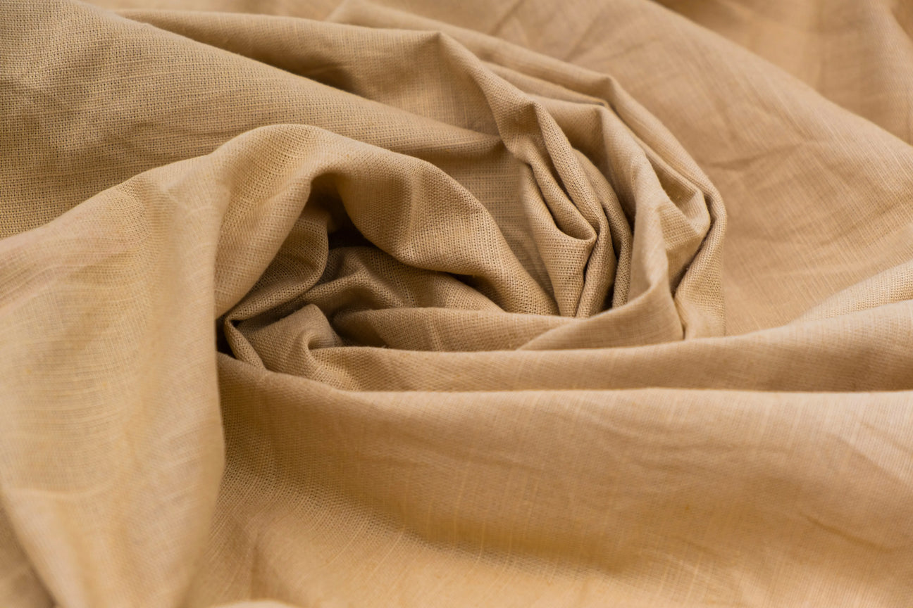 Natural sand-colored fabric with soft texture, ideal for sewing custom-made bedding and stylish home textiles.
