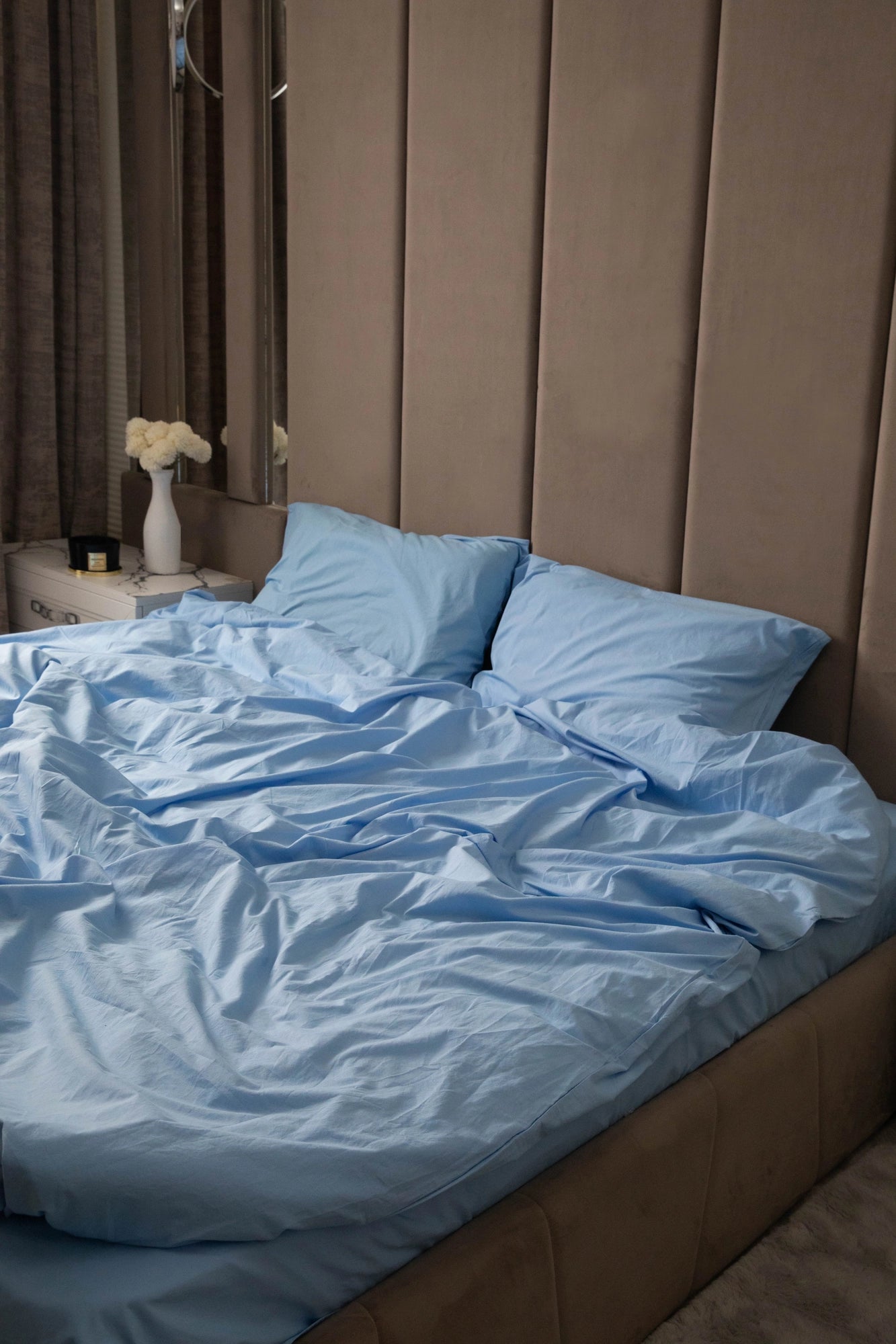 Supreme Rest bed dressed in eco-friendly, sky blue sheets with a lived-in, crafted look—effortless elegance in a serene bedroom setting