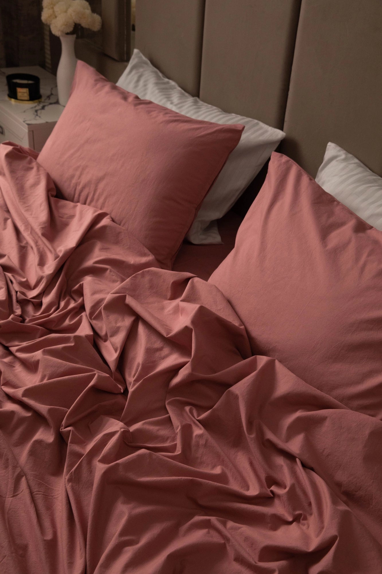 Supreme Rest stonewashed cotton bedding in rosewood, artfully rumpled for a relaxed, lived-in look—a custom-made, eco-friendly set designed for everyday luxury