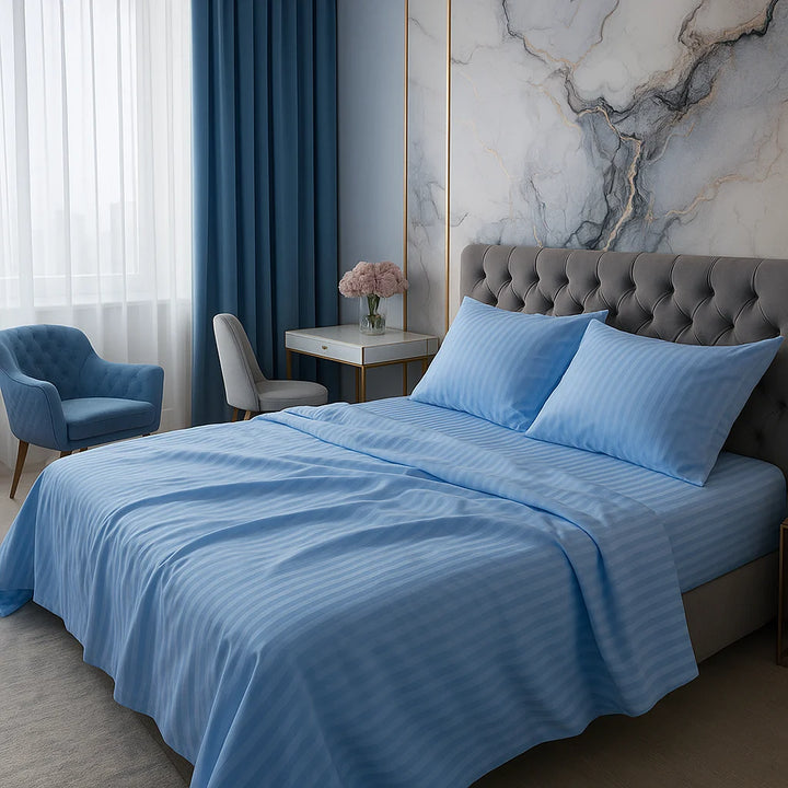 Supreme Rest custom hand-crafted sky blue bedding set, showcased in a luxury suite with a tufted velvet headboard, marble accent wall, and soft natural ligh t— designed for elevated sleep and timeless sophistication
