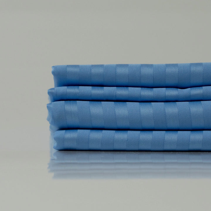 Close-up of Celestial Blue duvet cover’s elegant striped pattern in soft sateen cotton.