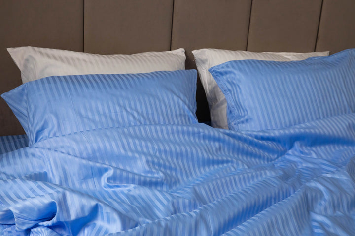 Close-up of Supreme Rest Celestial Blue pillowcase with a subtle striped sateen texture.