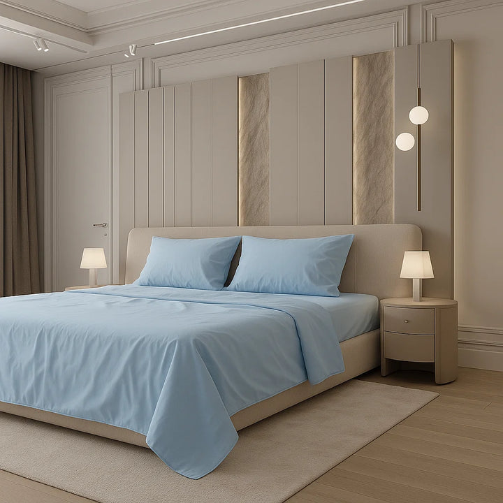 Contemporary sanctuary featuring a minimalist cream bed adorned with serene sky-blue bedding, flanked by sculptural lighting and fluted paneling with soft golden accents — the essence of quiet luxury