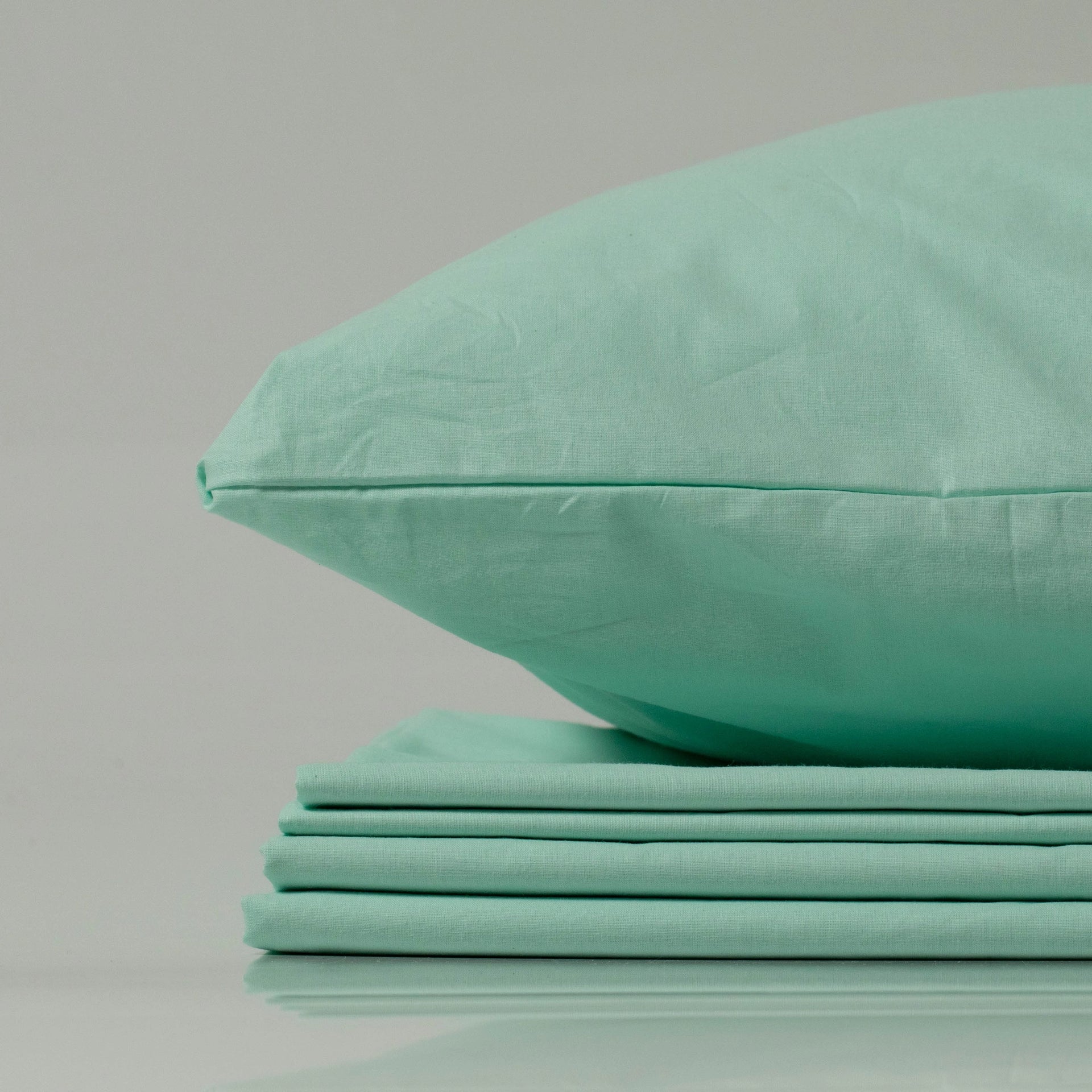 Close-up of a neatly stacked Supreme Rest Glacial Waters ranforce bedding set with a matching pillowcase on top