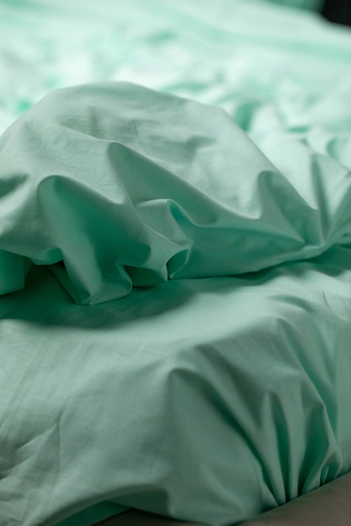 Close-up of Supreme Rest Glacial Waters ranforce fabric with soft folds, showcasing its smooth texture and breathable quality.