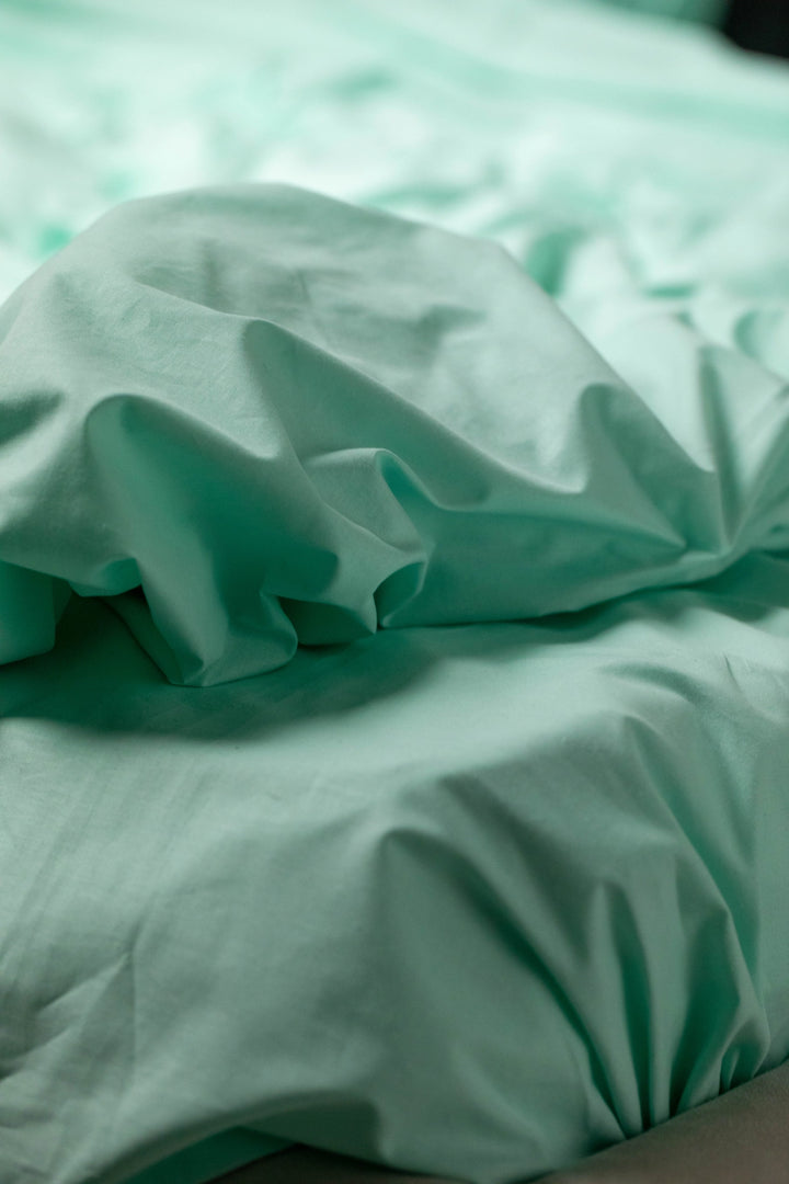 Close-up of Supreme Rest Glacial Waters ranforce fabric with soft folds, showcasing its smooth texture and breathable quality.