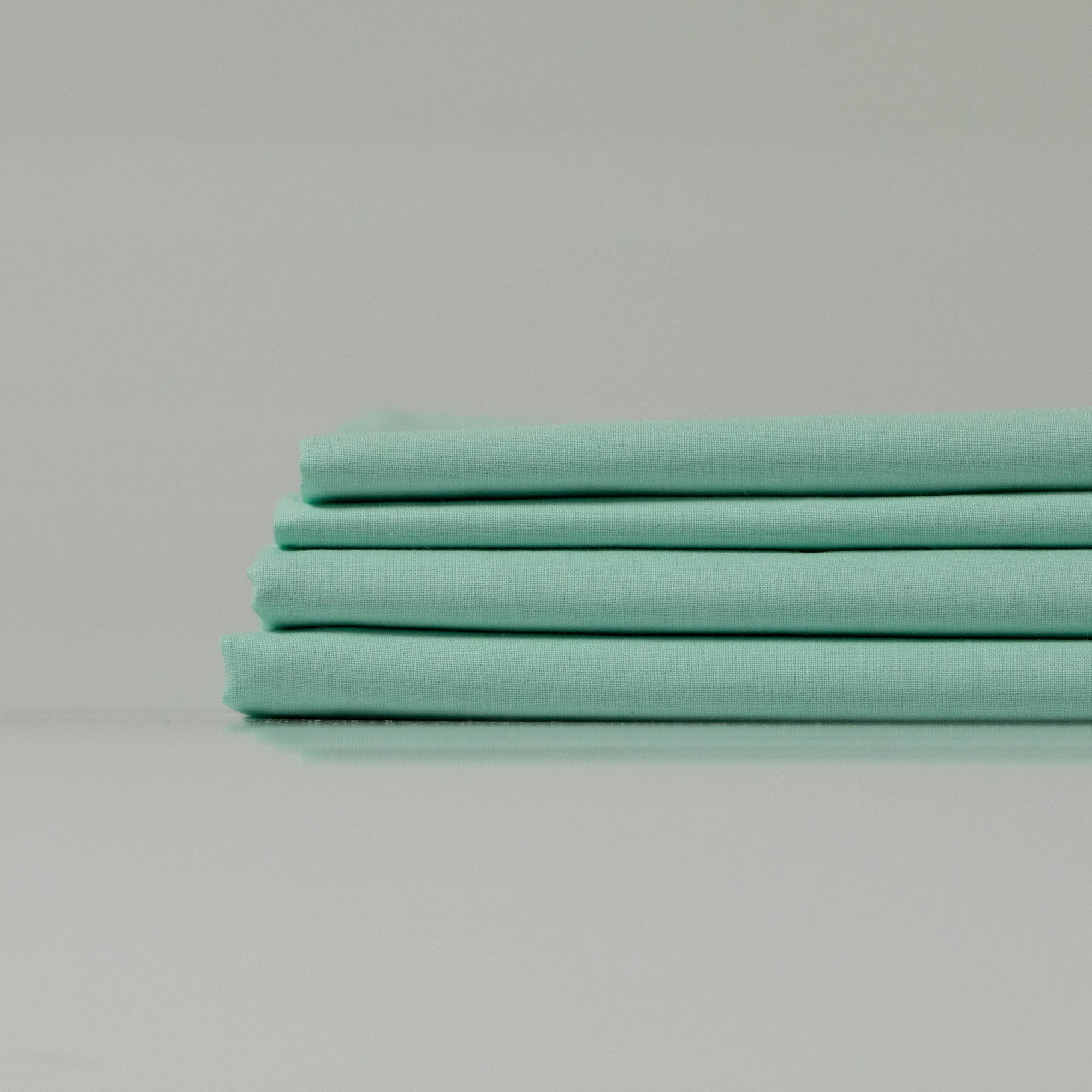 Neatly folded Supreme Rest Glacial Waters ranforce sheets stacked for a clean presentation