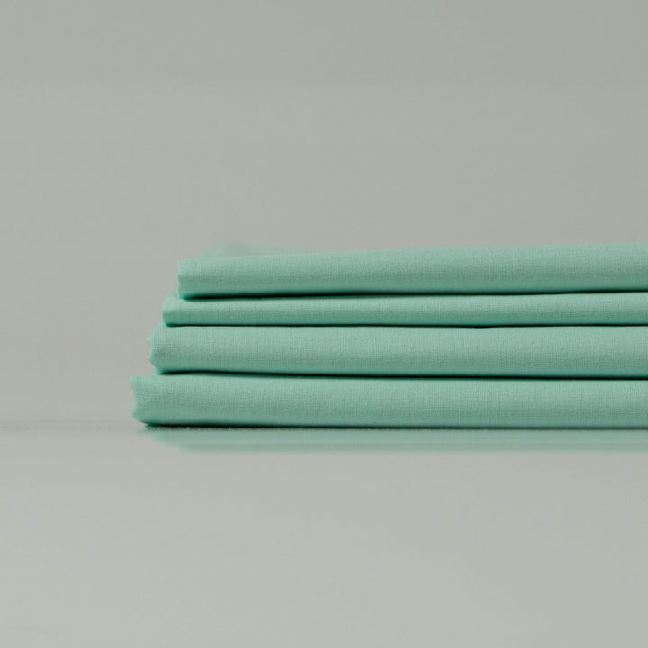 Neatly folded Supreme Rest Glacial Waters ranforce sheets stacked for a clean presentation