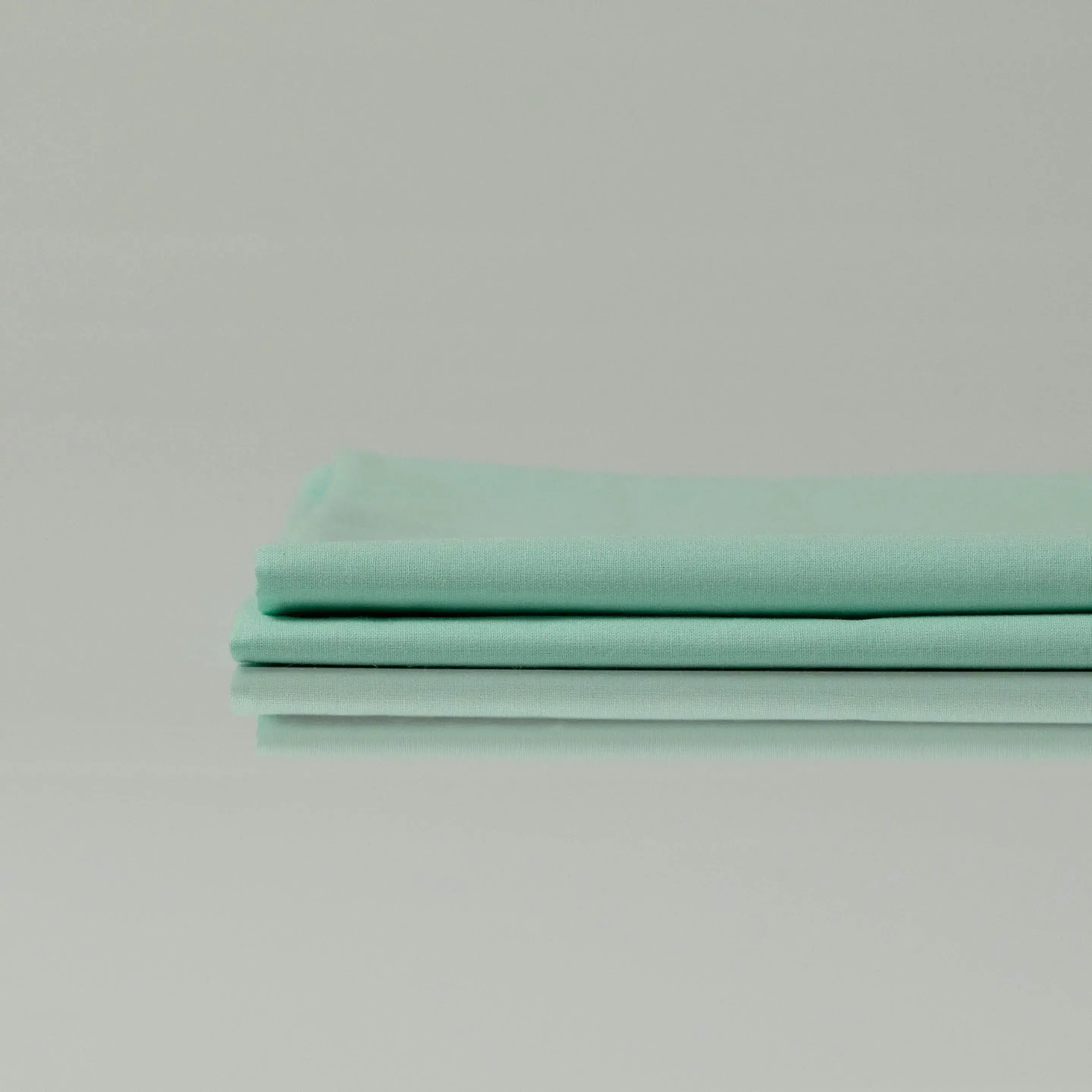 Supreme Rest Glacial Waters folded sheet set – eco-friendly custom bedding in soft aqua tone for elegant, sustainable sleep comfort.