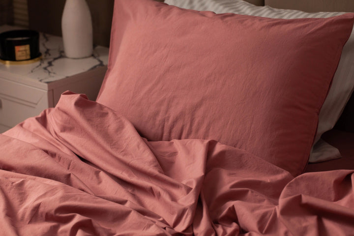 Close-up of Supreme Rest’s rosewood cotton pillow and bedding—crafted for softness and elegance with eco-friendly materials and a refined custom-made touch