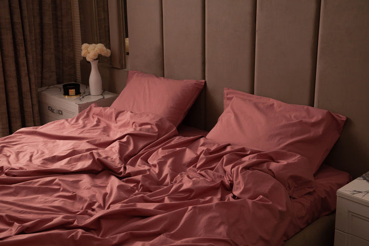 Supreme Rest stonewashed cotton bedding in a rich rosewood hue, styled in a plush bedroom setting—crafted for softness, comfort, and eco-friendly everyday indulgence
