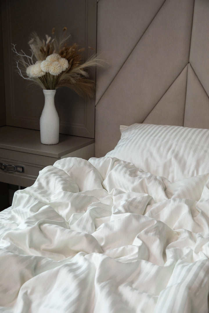 A cozy and inviting bedroom with Supreme Rest’s Ivory Dune bedding set in soft, natural light.