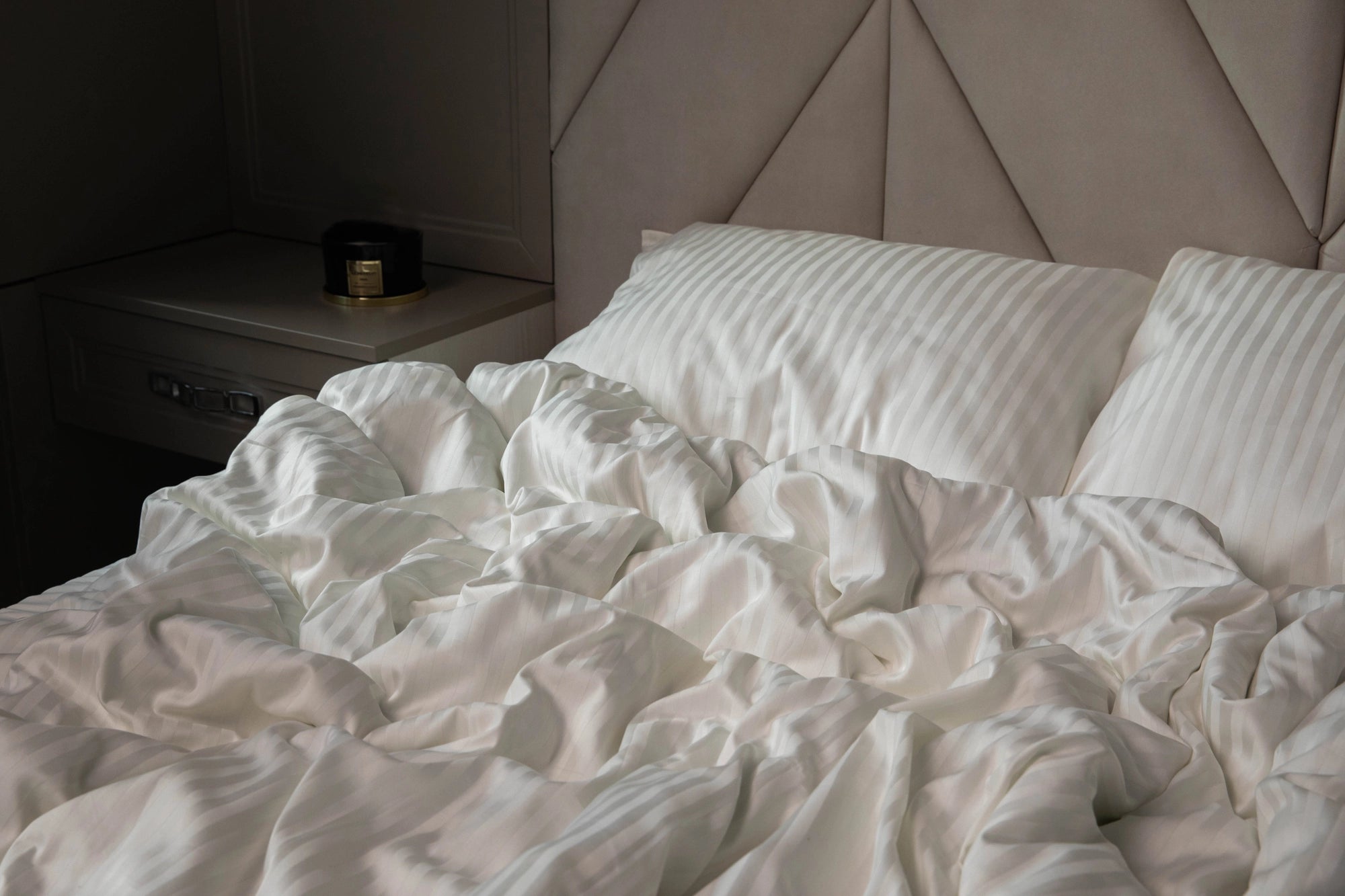 Warm and serene sleeping space styled with Supreme Rest Ivory Dune bedding.