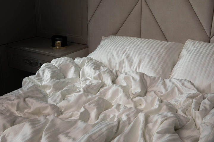Warm and serene sleeping space styled with Supreme Rest Ivory Dune bedding.