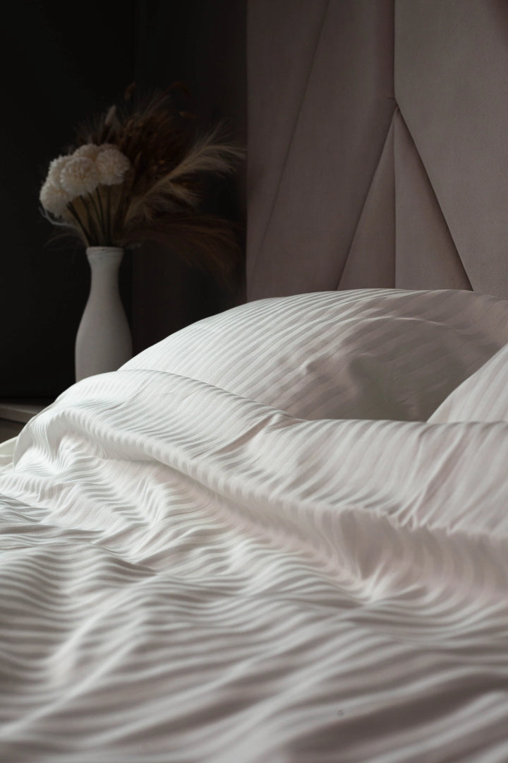 Close-up of Ivory Dune sateen fabric, featuring delicate stripes and a soft, breathable weave.