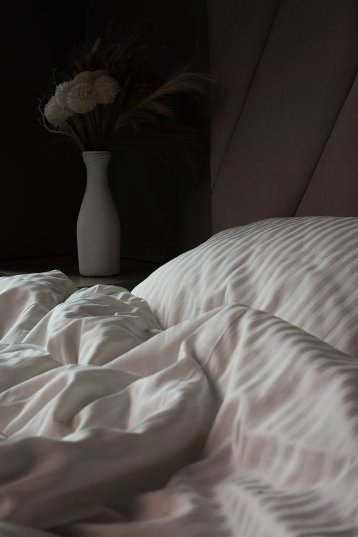 Supreme Rest Ivory Dune sateen sheets, emphasizing their silky texture and durability.