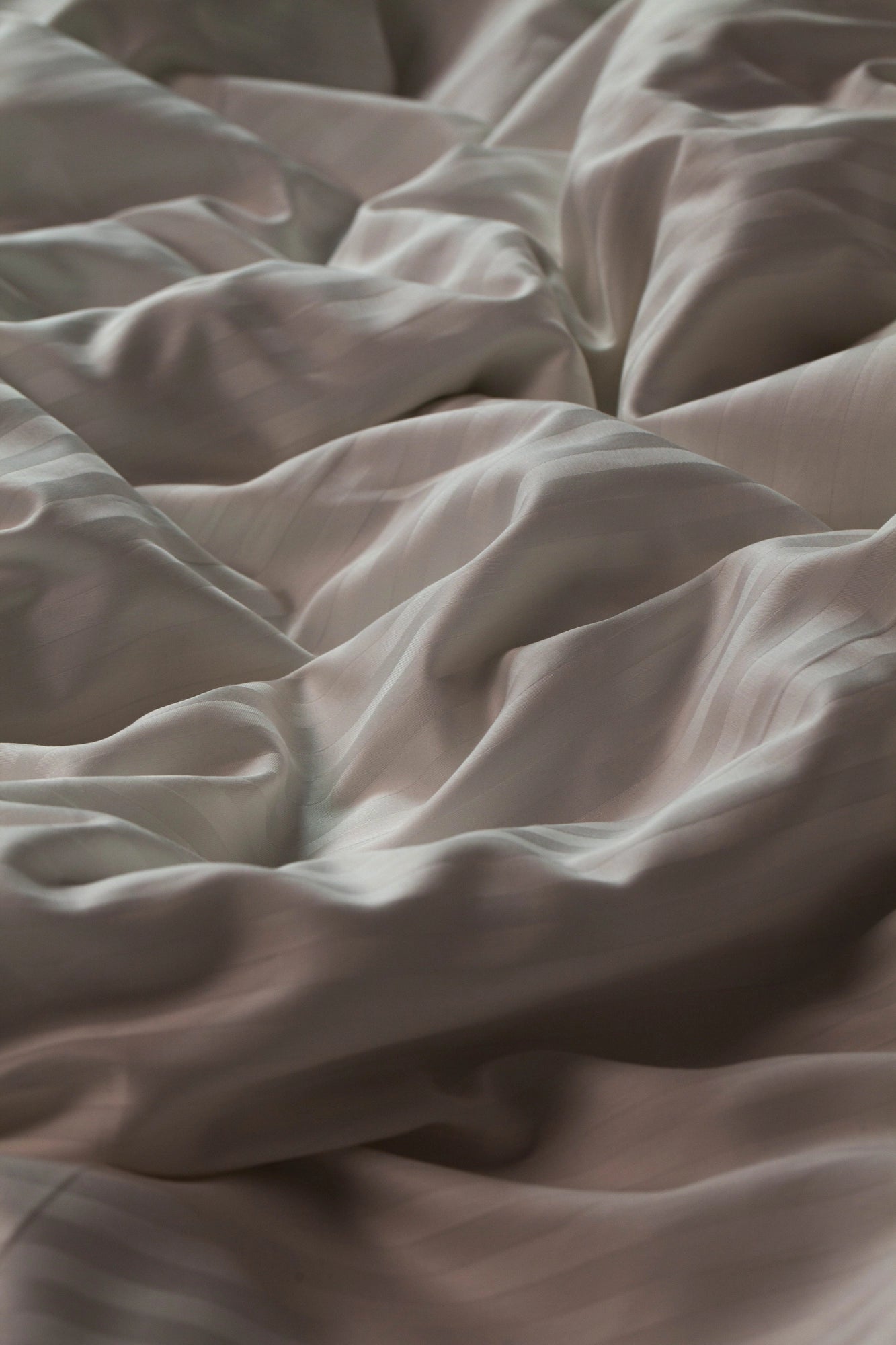 Wrinkled Supreme Rest Ivory Dune duvet cover, showcasing its soft and breathable fabric.