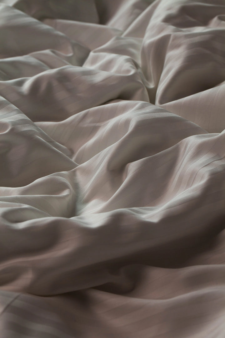 Wrinkled Supreme Rest Ivory Dune duvet cover, showcasing its soft and breathable fabric.