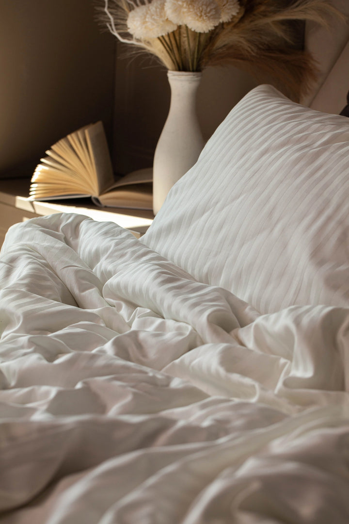Warm and serene sleeping space styled with Supreme Rest Ivory Dune bedding.