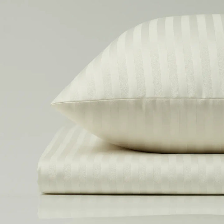 Supreme Rest Ivory Dune striped pillow and sheet set – eco-friendly custom bedding crafted for elegant, hotel-style luxurious sleep.