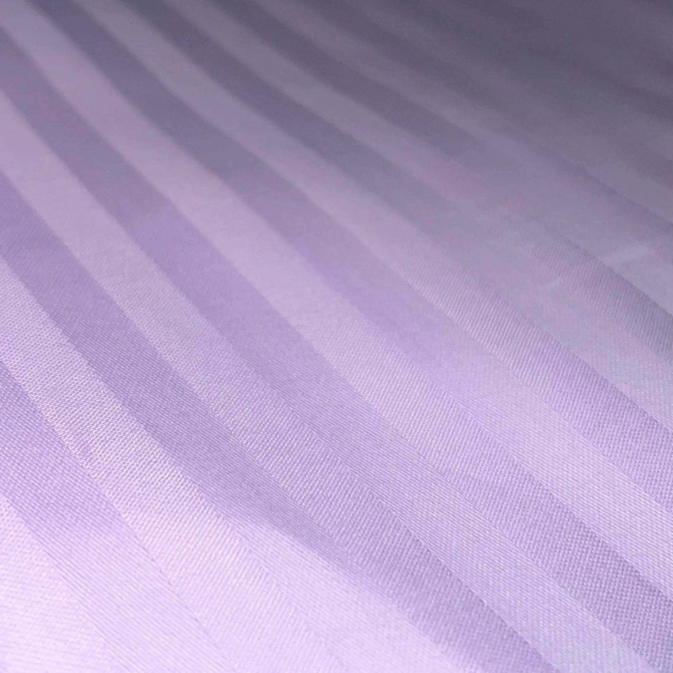 Close-up of Supreme Rest striped lavender sateen sheet – handcrafted, eco-friendly bedding for luxury sleep.