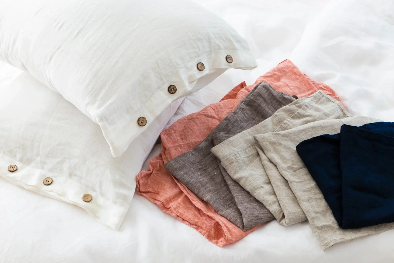 Handmade linen pillowcases and sheets in a range of earthy colors—sustainable comfort, one layer at a time.