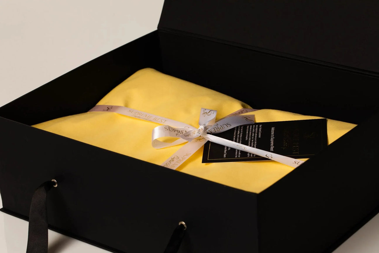 Luxurious personalized bedding set neatly arranged on a bed, showcasing premium fabrics, custom embroidery, and elegant packaging from Supreme Rest