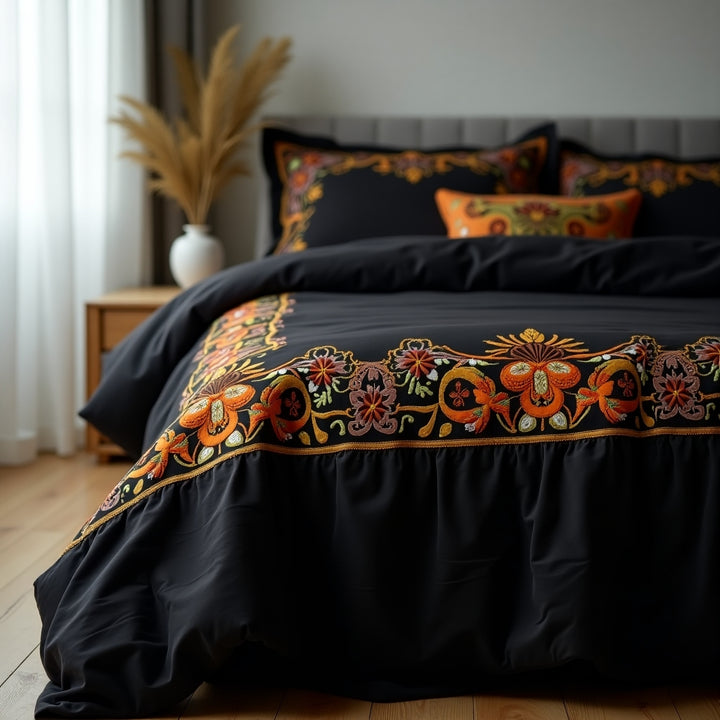 Black embroidered bedding set on a bed with decorative pillows in a bedroom setting.