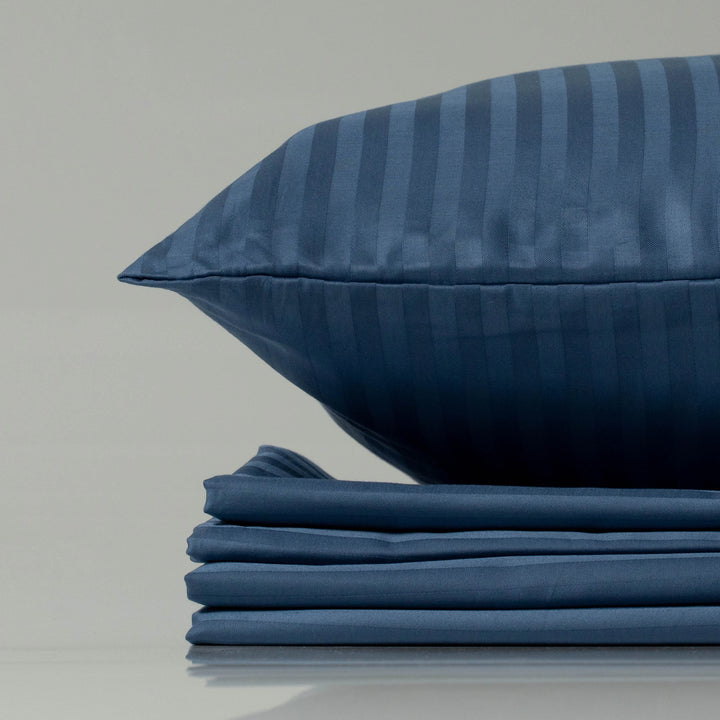 Navy blue striped sateen pillow and folded sheet set - eco-friendly, custom-crafted luxury from Supreme Rest