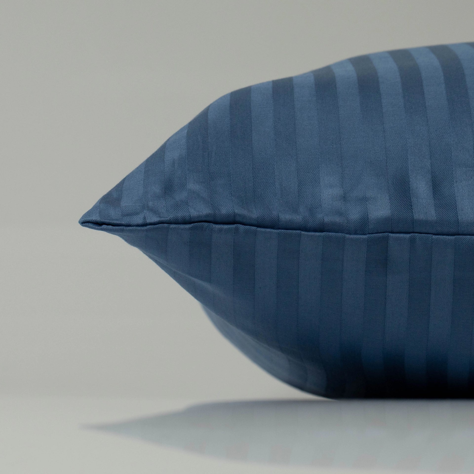 A Supreme Rest pillow in ocean blue with a refined striped pattern, crafted from custom eco-friendly fabric for a luxurious, tailored finish