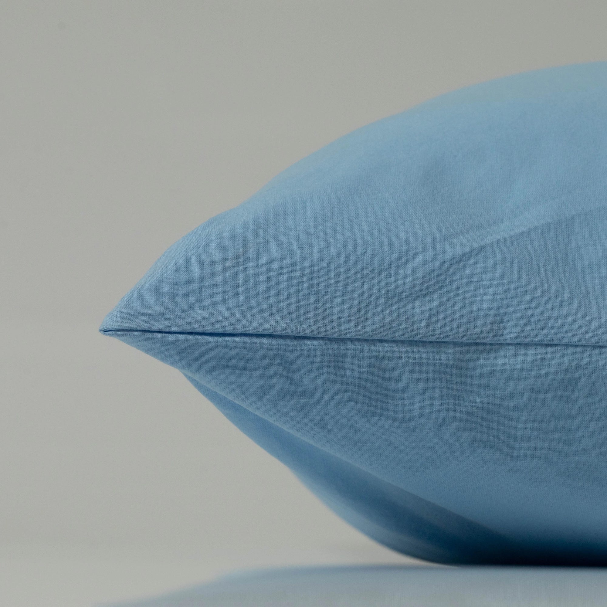 Stonewashed cotton pillowcase in airy sky blue, custom-crafted by Supreme Rest for eco-friendly comfort and artisanal softness.