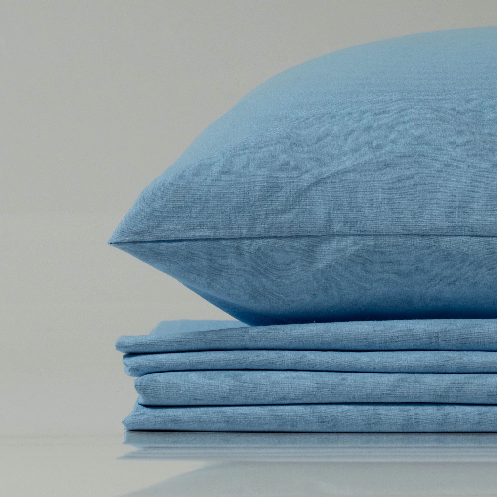 Sky-blue stonewashed cotton bedding set with pillowcase, custom-made for a soft, lived-in feel - crafted with care by Supreme Rest using eco-friendly materials