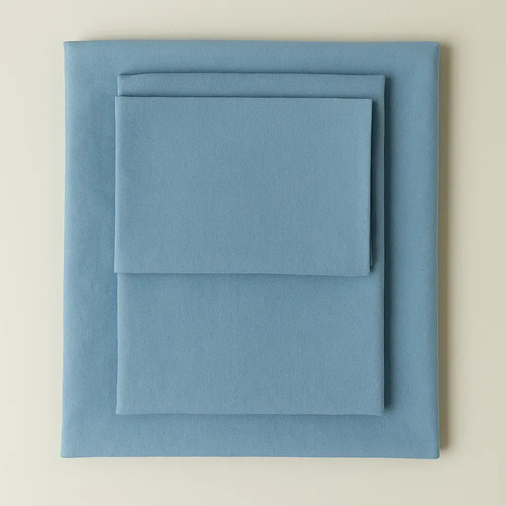 Supreme Rest eco-friendly custom-made bedding set in soft blue – folded sheets and pillowcase for luxurious, sustainable sleep.