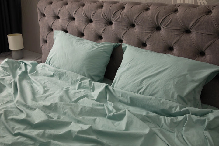 Supreme Rest’s custom made sage green bedding set styled on a tufted headboard bed, offering an inviting blend of softness and eco-friendly comfort