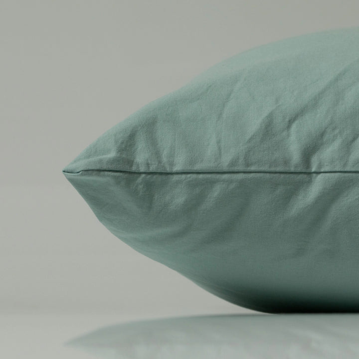  Close-up of a mint green pillow from Supreme Rest, showcasing custom made stitching and eco-friendly fabric in a soft, contemporary finish