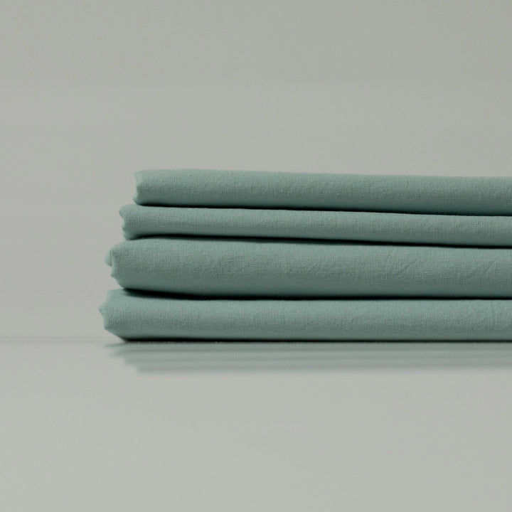 Mint green folded eco-friendly fabric - custom-crafted by Supreme Rest for sustainable bedding essentials.