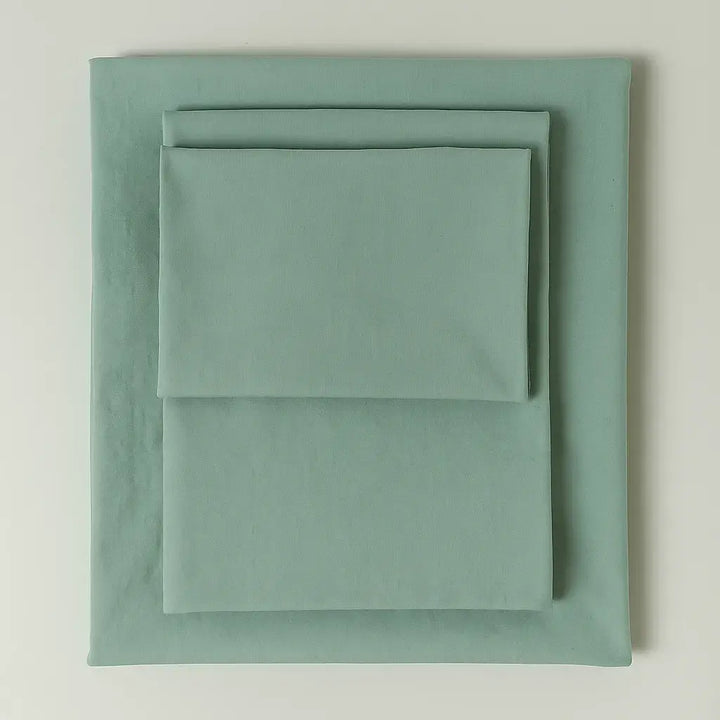 Supreme Rest eco-friendly custom-made bedding set in soft mint green tone – folded sheets and pillowcase for sustainable luxury sleep.