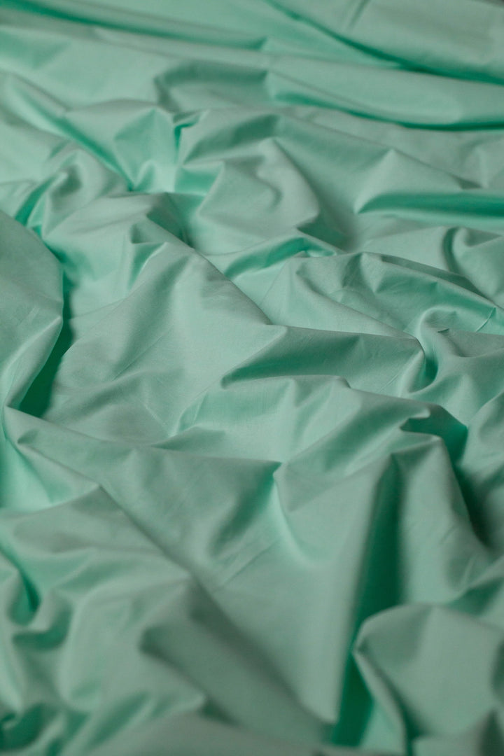 Soft and smooth Glacial Waters ranforce bedding set arranged on a bed for a serene aesthetic