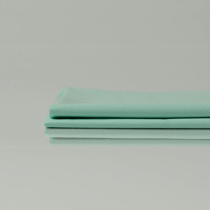 Supreme Rest Glacial Waters folded sheet set – eco-friendly custom bedding in soft aqua tone for elegant, sustainable sleep comfort.