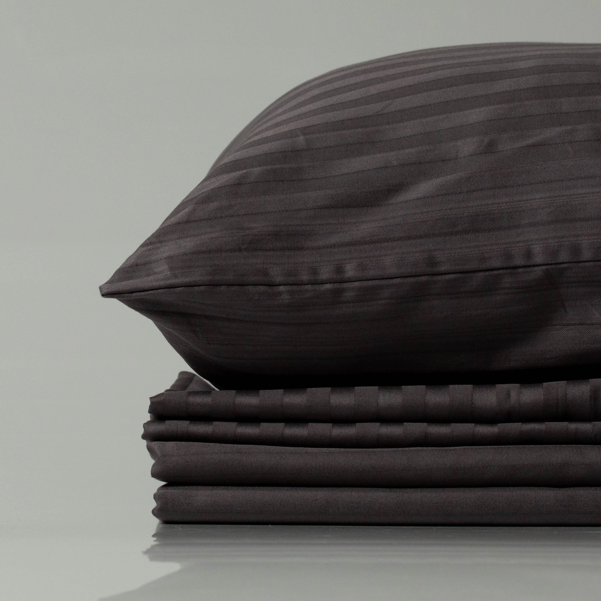 Supreme Rest deep charcoal striped bedding set, showcasing eco-friendly, custom made craftsmanship with a luxurious touch