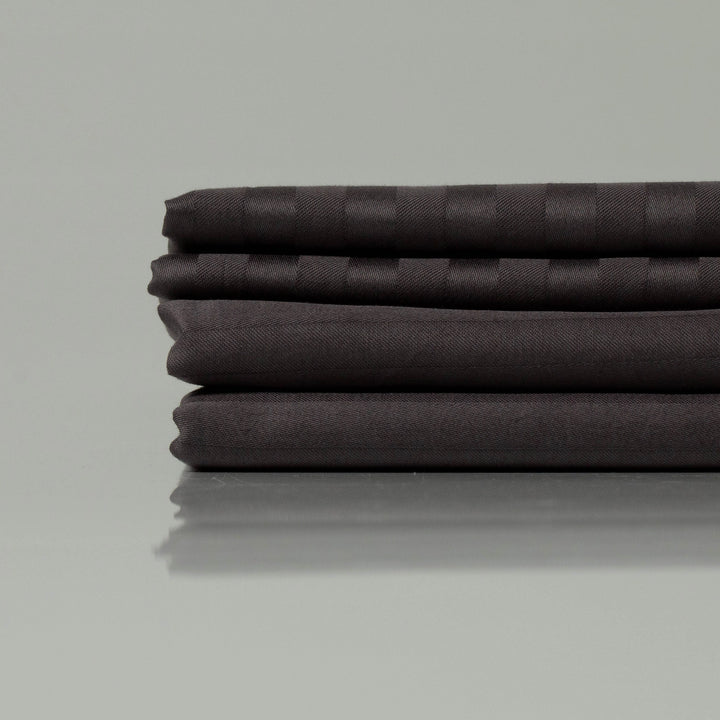 Supreme Rest's eco-friendly dark striped sateen sheets, neatly folded to showcase refined texture and premium craftsmanship