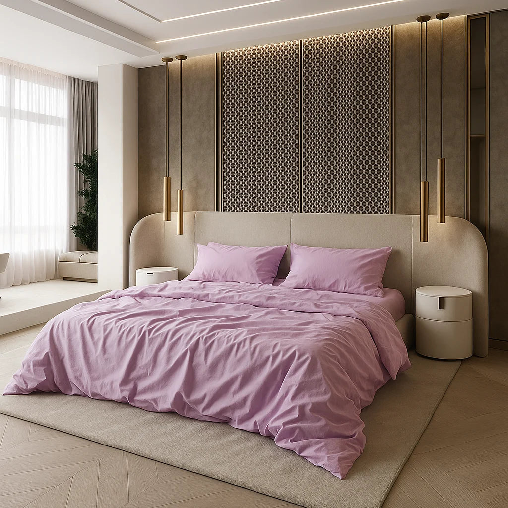 Modern elegance meets softness—blush pink Supreme Rest sheets draped effortlessly on a sculpted cream bed, framed by warm gold lighting