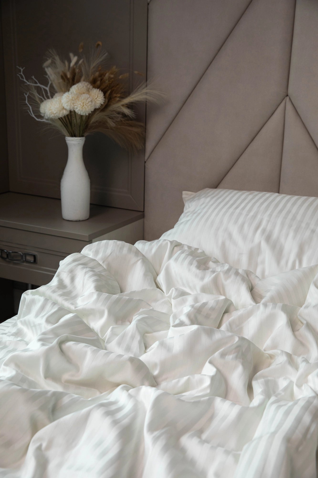 A cozy and inviting bedroom with Supreme Rest’s Ivory Dune bedding set in soft, natural light.