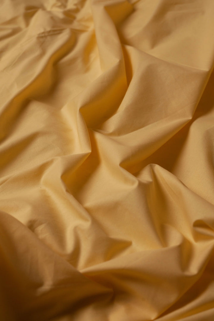 Wrinkled Lemon Sunbeam duvet cover showcasing the softness and natural texture of ranforce cotton.