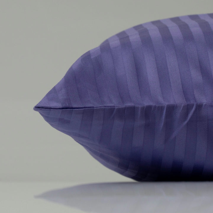 Deep purple pillowcase with a striped sateen finish, adding a touch of sophistication to the bed.