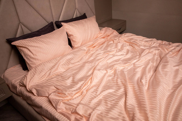 Blush peach Supreme Rest bedding set in sateen stripes, custom made for a luxurious and eco-friendly sleep experience