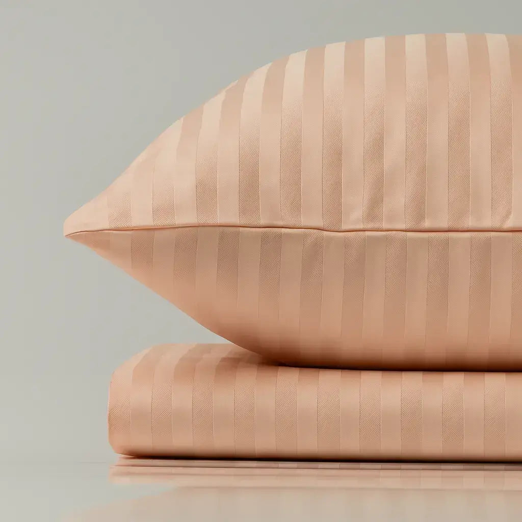 Supreme Rest peach striped pillow and sheet set – eco-friendly custom bedding combining handcrafted luxury with serene sleep comfort.