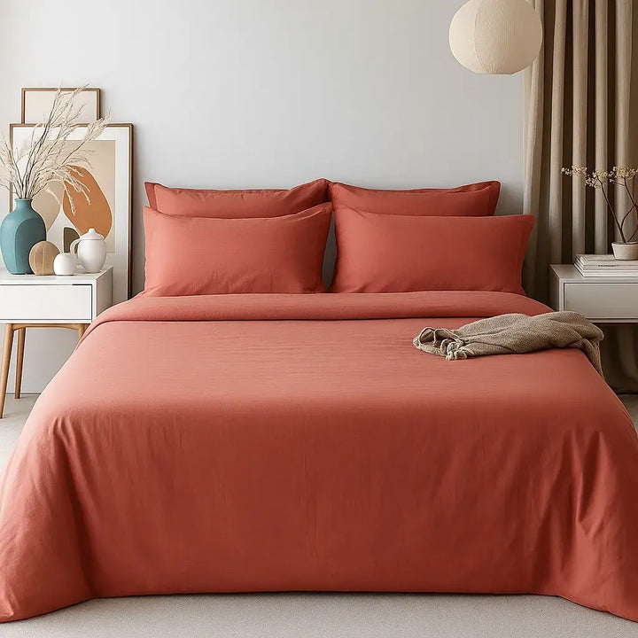 Minimalist bedroom featuring a muted terracotta cotton bedding set from Supreme Rest - styled with crisp lines, soft lighting, and warm earthy tones for a serene, natural sleep sanctuary