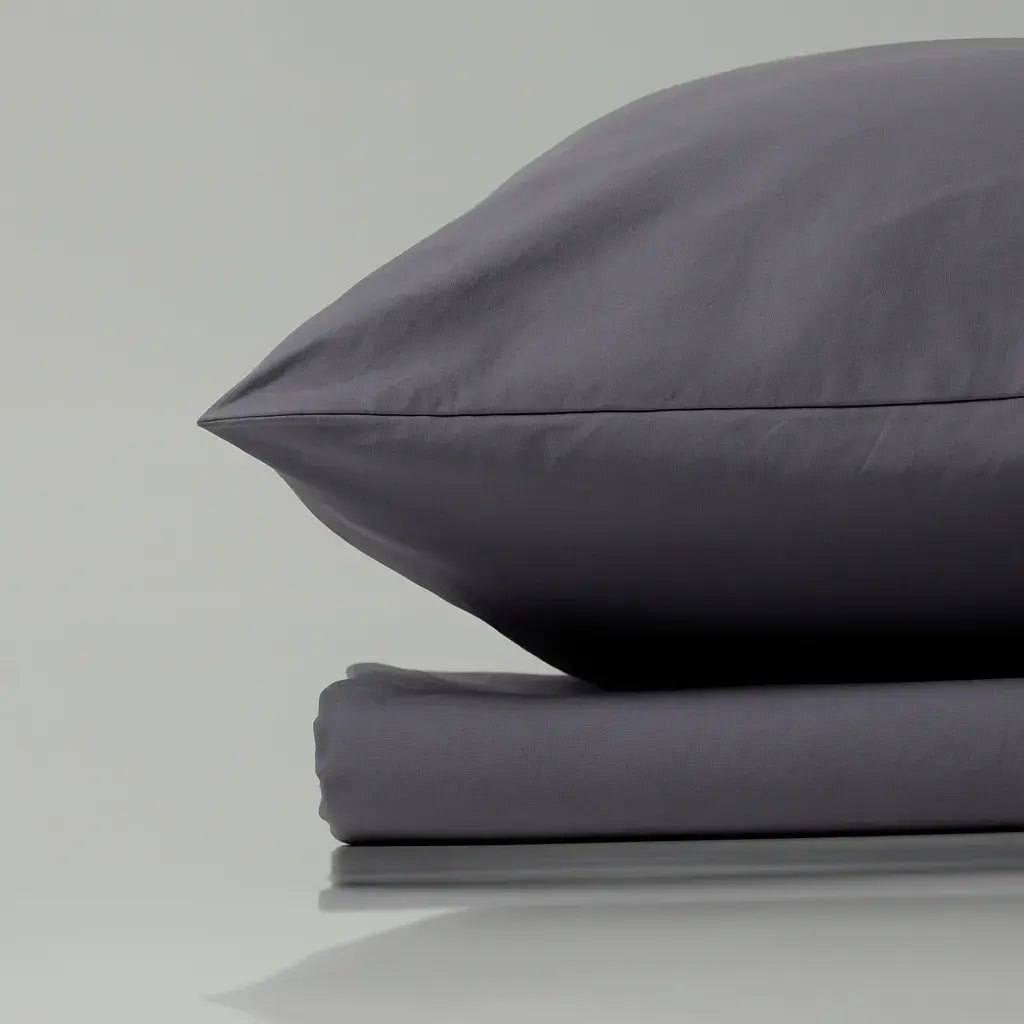 Supreme Rest’s custom-made slate grey bedding set—featuring finely folded sheets and a perfectly plump pillow—embodies our eco-friendly approach and quiet luxury through every tailored detail.
