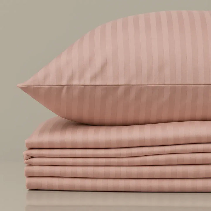 Folded pink stripe sateen bedding set “Strawberry Soufflé” with matching pillowcase, luxury cotton sheets.